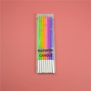 Detailed view of six slim rainbow gradient birthday candles with silver foil bases
