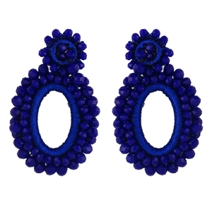 Detail of handmade bohemian dark blue seed bead earrings with oval drop design