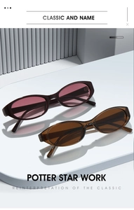 Detail view of oval retro sunglasses in dark red and tea brown lenses on display