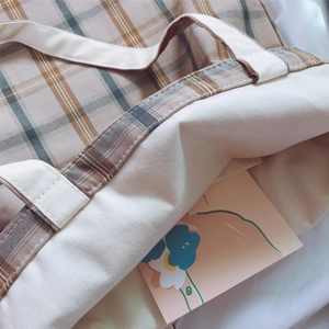 Detailed close-up of checkered canvas tote bag showing interior lining and stitching