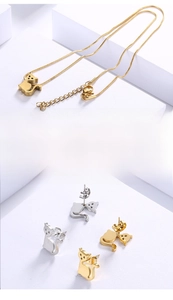 Macro shot of minimalist cat-shaped pendant and stud earrings set in gold and silver