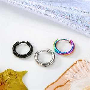 Detailed view of polished thick stainless steel hoop earrings in black, silver and rainbow