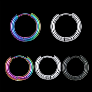 Detail view of round hoop earrings in iridescent, silver, and matte black steel finishes