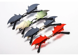 Detail of four colorful bat wing rimless sunglasses with metal temples on white background