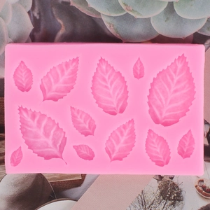 Detail view of pink silicone leaf mold with twelve cavities showing intricate vein textures