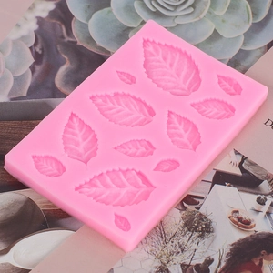 Macro shot of pink silicone mold with various leaf patterns for DIY fondant cake baking
