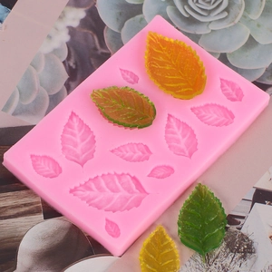 Detailed pink silicone mold with various leaf shapes and finished leaf cake decorations