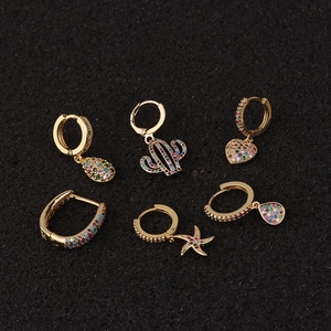 Detail of gold bohemian earring set featuring colorful zircon cactus and starfish charms