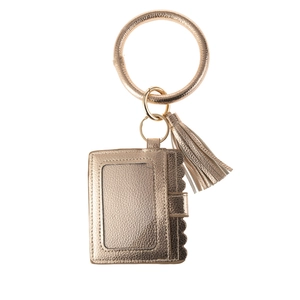 Detail of champagne gold lychee grain PU leather wristlet with tassel and card holder