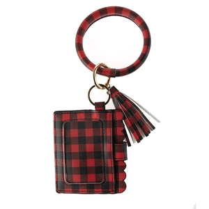 Detail of red and black buffalo plaid PU leather wristlet keychain with fringe tassel