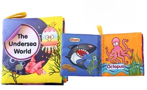 Detail of washable undersea world cloth book with shark patterns and yellow handle
