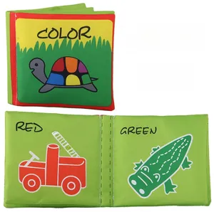 Detail of baby cloth book showing colorful turtle, red fire truck and green crocodile pages