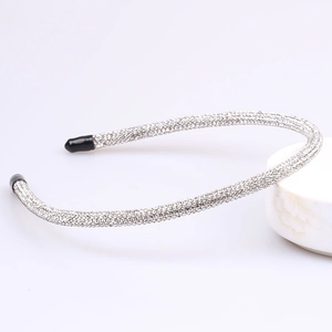 Detail of silver-toned slim headband with full crystal rhinestones and black rubber tips