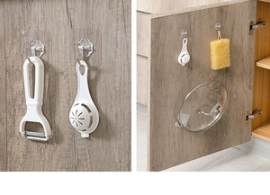 Strong transparent adhesive hooks for kitchen storage showing heavy kitchenware hanging