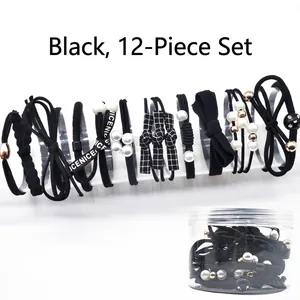 Set of 12 black elastic hair ties with pearls and bows in a clear storage jar