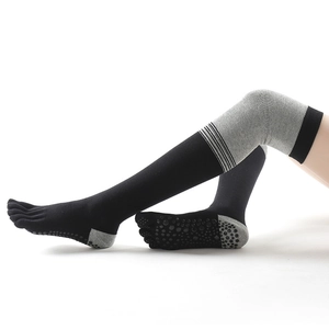 Over-knee yoga socks in black and grey with non-slip grips and striped design