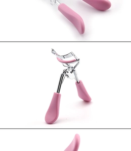 Close-up of portable pink eyelash curler with silver metal head and soft rubber pad