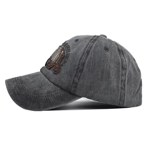 Detail of bear embroidery patch on dark gray distressed washed cotton baseball cap