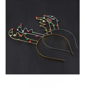 Close-up of gold and silver Christmas reindeer antler headbands with colorful bells
