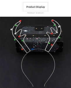 Detail of silver reindeer antler headband decorated with festive red and green mini bells