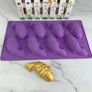 Purple silicone koi fish mold for chocolate and soap making with golden fish sample