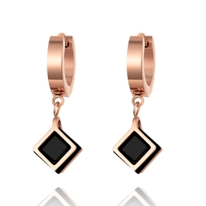 Minimalist geometric rhombic earrings with rose gold finish and black charm on white background