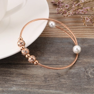 Rose gold spiral stainless steel bracelet with double pearls and pavé crystal beads