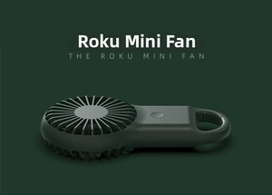 Detail view of the green mini pocket fan with a portable carabiner ring and grille head