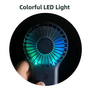 Detail of portable mini fan with vibrant 7-color LED light effects on black background