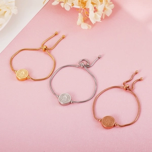 Detailed view of adjustable Saint Benedict round coin bracelets in gold, silver, and rose gold