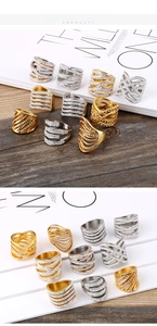 Detail of layered stainless steel rings with gold plating and sparkling zircon inlay
