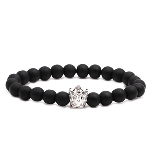 Matte black beaded bracelet featuring a silver alloy crown charm on a clean white background
