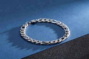 Macro shot of silver-toned stainless steel 3:1 NK chain bracelet with lobster clasp