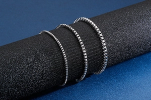Detailed macro view of three silver stainless steel box chains in different thicknesses