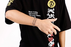 Detail of silver stainless steel box chain multi-layer bracelet on a model wrist