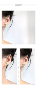 Detail view showing golden gardenia flower earrings with a matte frosted texture on a model