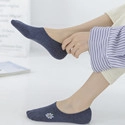 Detail of dark blue cotton ankle sock featuring a delicate white flower embroidery on the side