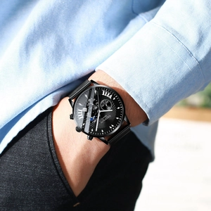 Business men's black quartz watch with mesh strap and calendar dial on male wrist