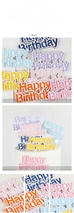 Detail view of colorful paper Happy Birthday cake toppers in soft macaron shades for baking