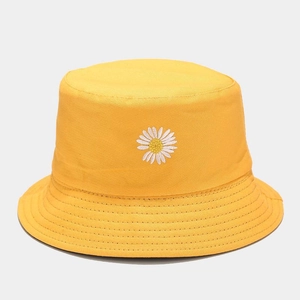 Detailed close-up of delicate daisy flower embroidery on yellow cotton bucket hat