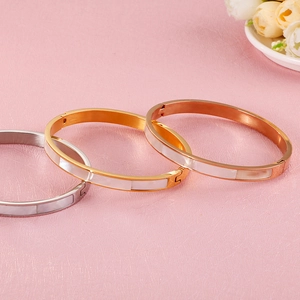 Three-piece stainless steel bangle set in silver gold and rose gold with shell inlays