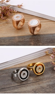 Detail of rose gold ring with mother of pearl inlay and Roman numeral engraving