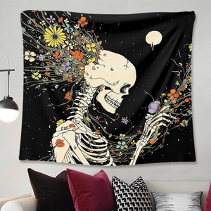 Detail of gothic floral skull tapestry hanging on wall in a cozy boho living room setting