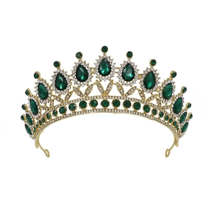 Detail of baroque gold bridal crown with green teardrop crystals and clear rhinestones