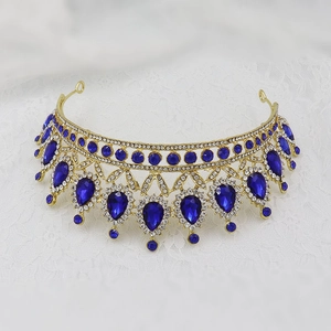 Close-up of gold bridal crown featuring blue teardrop crystals and white rhinestones