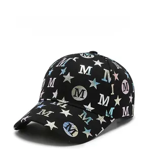 Detail of black baseball cap featuring holographic star patterns and laser M logo design