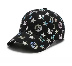 Detail of black cotton baseball cap featuring laser star patterns and letter M print