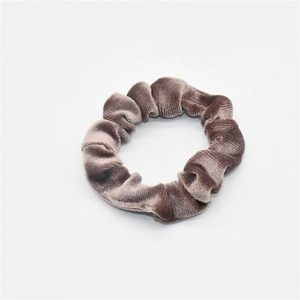 Close-up of velvet scrunchie showing detailed brown corduroy texture and premium fabric