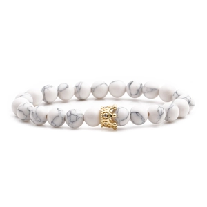 White turquoise beaded bracelet with golden crown charm on clean white background