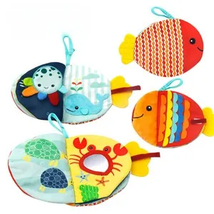 Macro view of ocean-themed baby cloth book with safety mirror and sensory sensory tabs